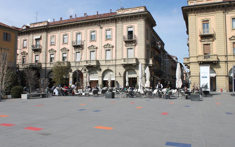 Elegant arcaded buildings and café terraces on Piazza Michele Ferrero in Alba