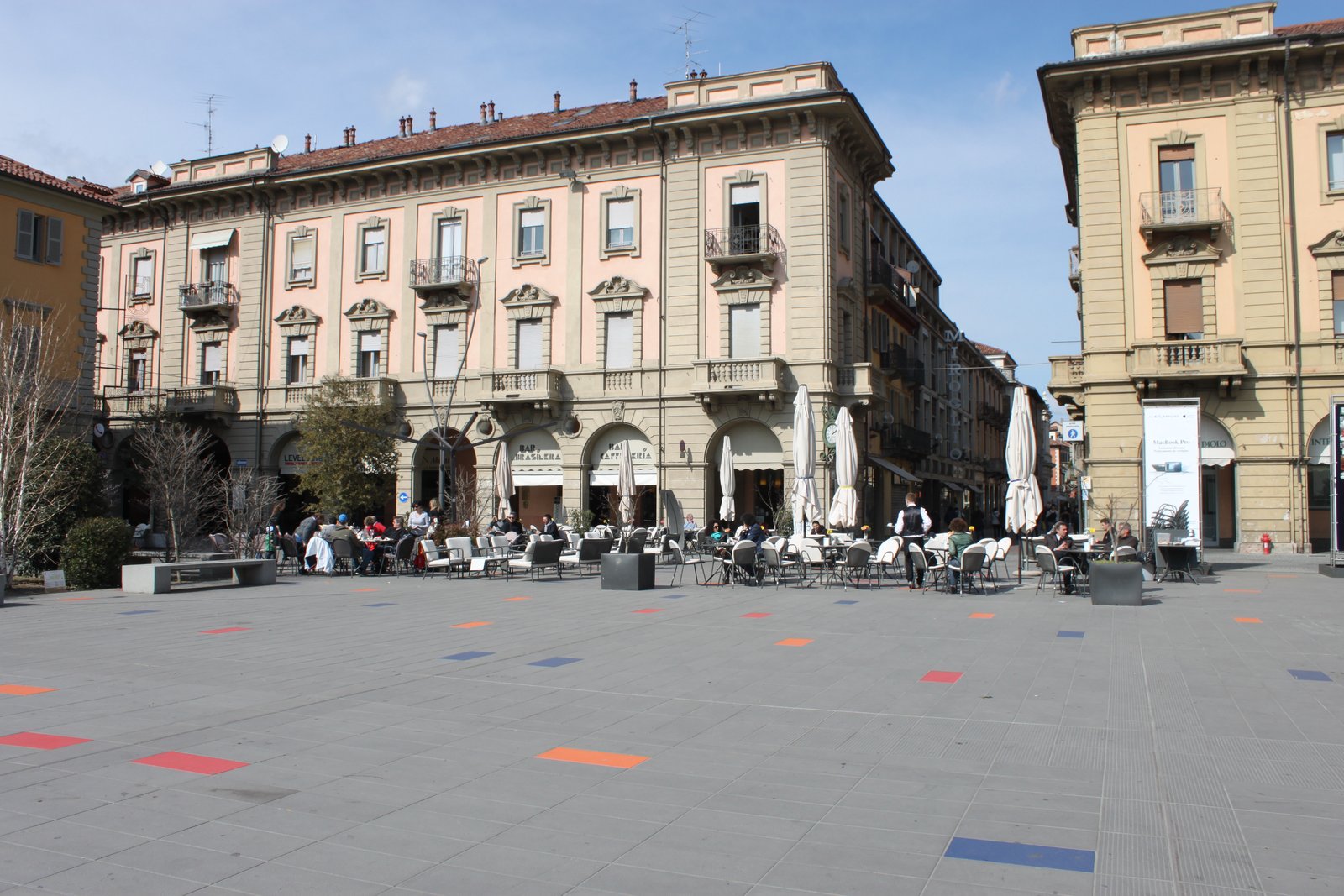 Elegant arcaded buildings and café terraces on Piazza Michele Ferrero in Alba