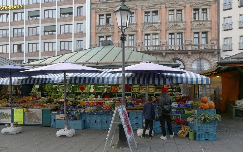 Fruit and vegetable stalls with striped awnings at the Viktualienmarkt in Munich