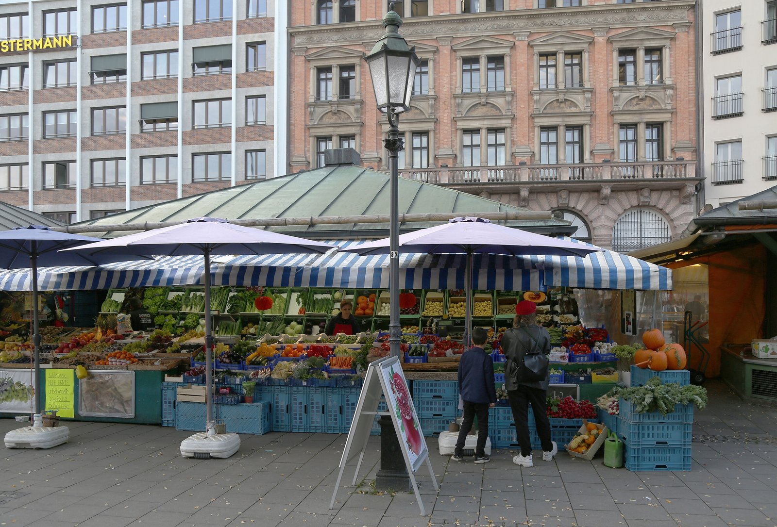 Fruit and vegetable stalls with striped awnings at the Viktualienmarkt in Munich