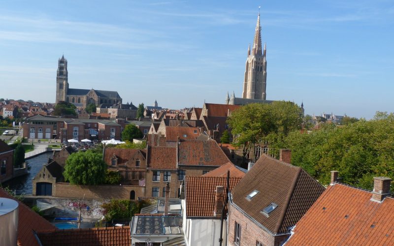 Bruges red roofs and church spires seen from the De Halve Maan brewery