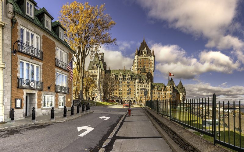 Château Frontenac seen from a street in Old Quebec under a dramatic sky