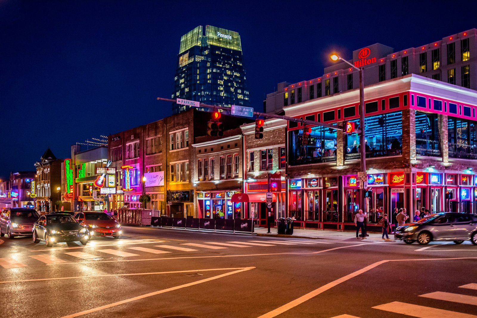 Neon-lit honky-tonks and restaurants on Broadway in downtown Nashville at night