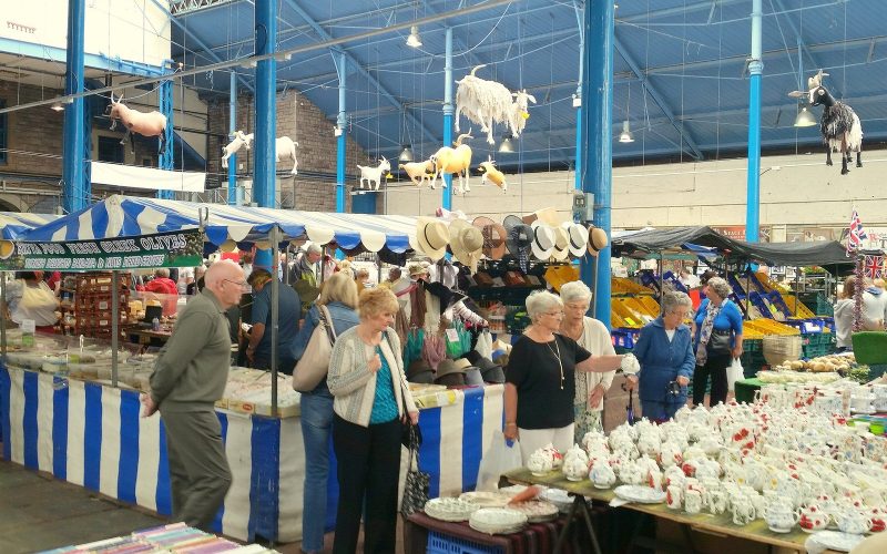 Stalls inside Abergavenny Market Hall under its iron and glass roof