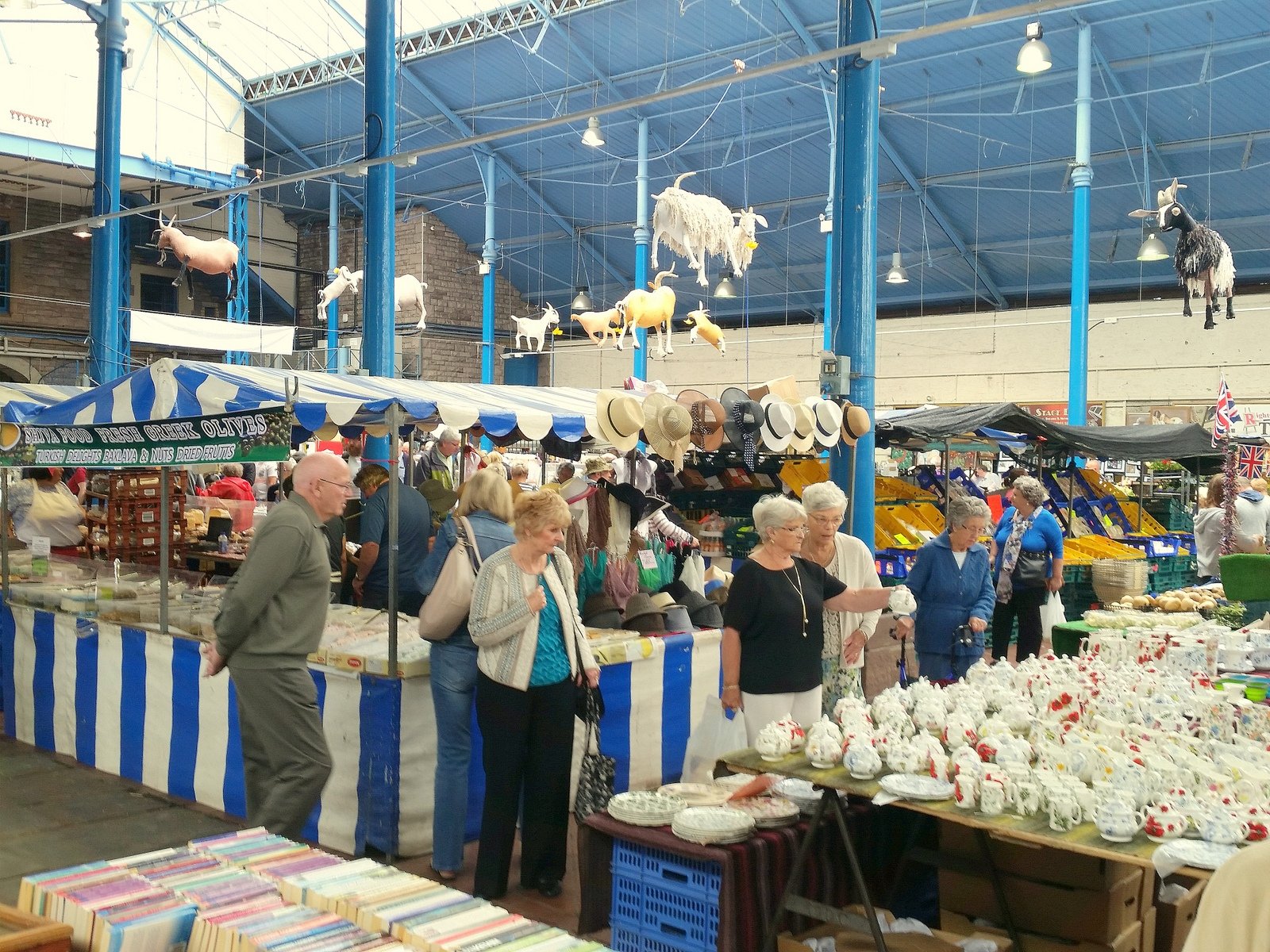 Stalls inside Abergavenny Market Hall under its iron and glass roof