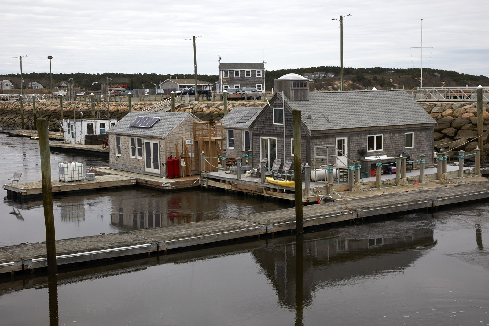 Weathered oyster shacks on floating docks in Wellfleet Harbor, Cape Cod