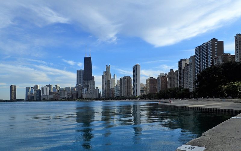 Chicago skyline seen from the Lake Michigan shore under a blue sky