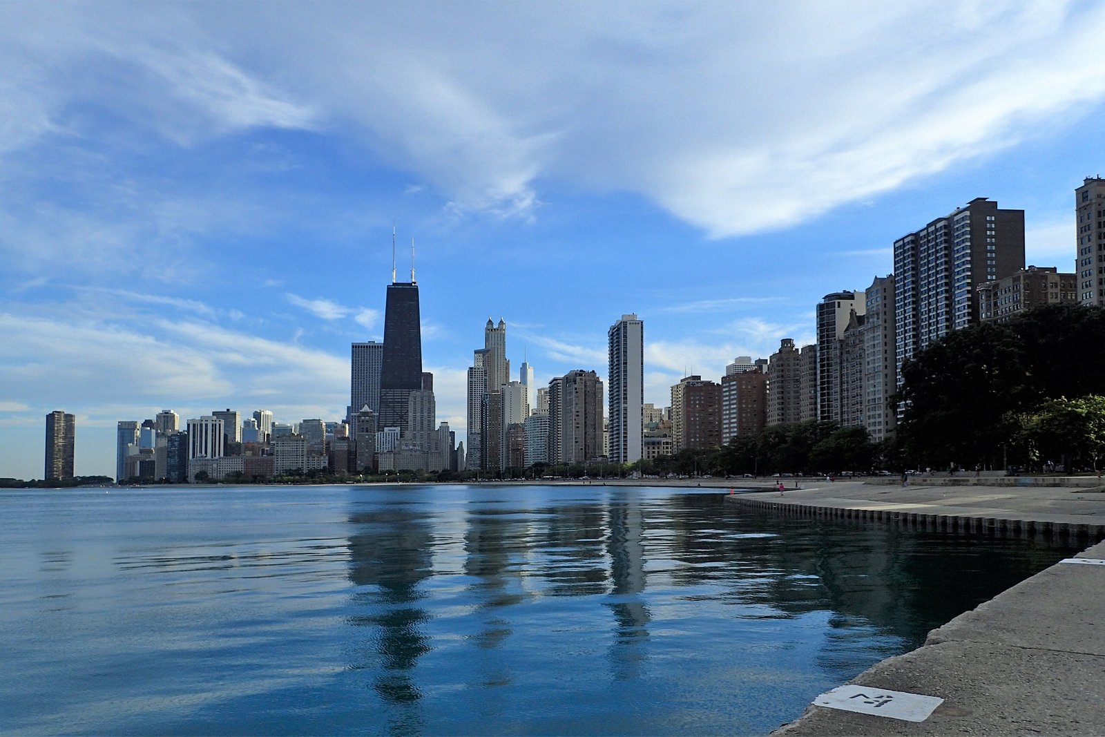 Chicago skyline seen from the Lake Michigan shore under a blue sky