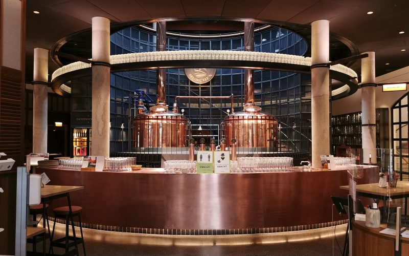 Copper brewing kettles behind the round bar at Paulaner am Nockherberg in Munich