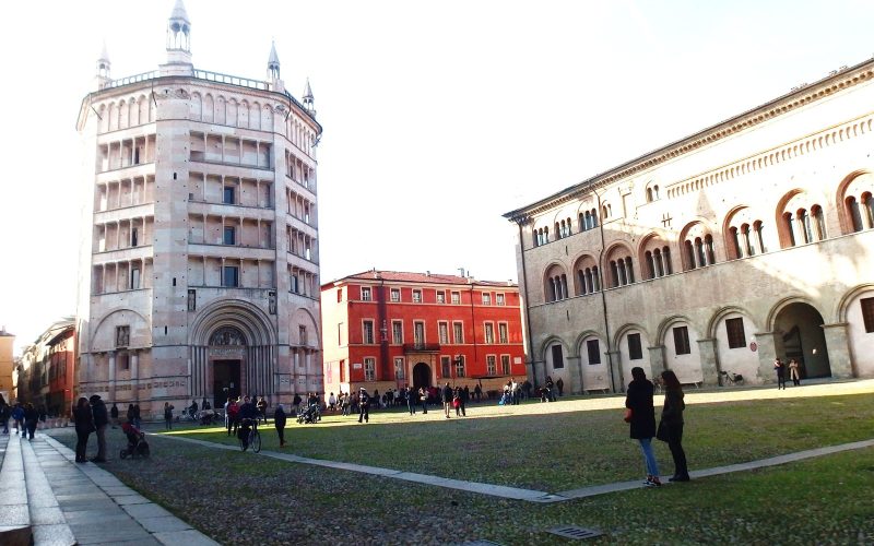 The Baptistery of Parma and the bishop's palace on a sunny square