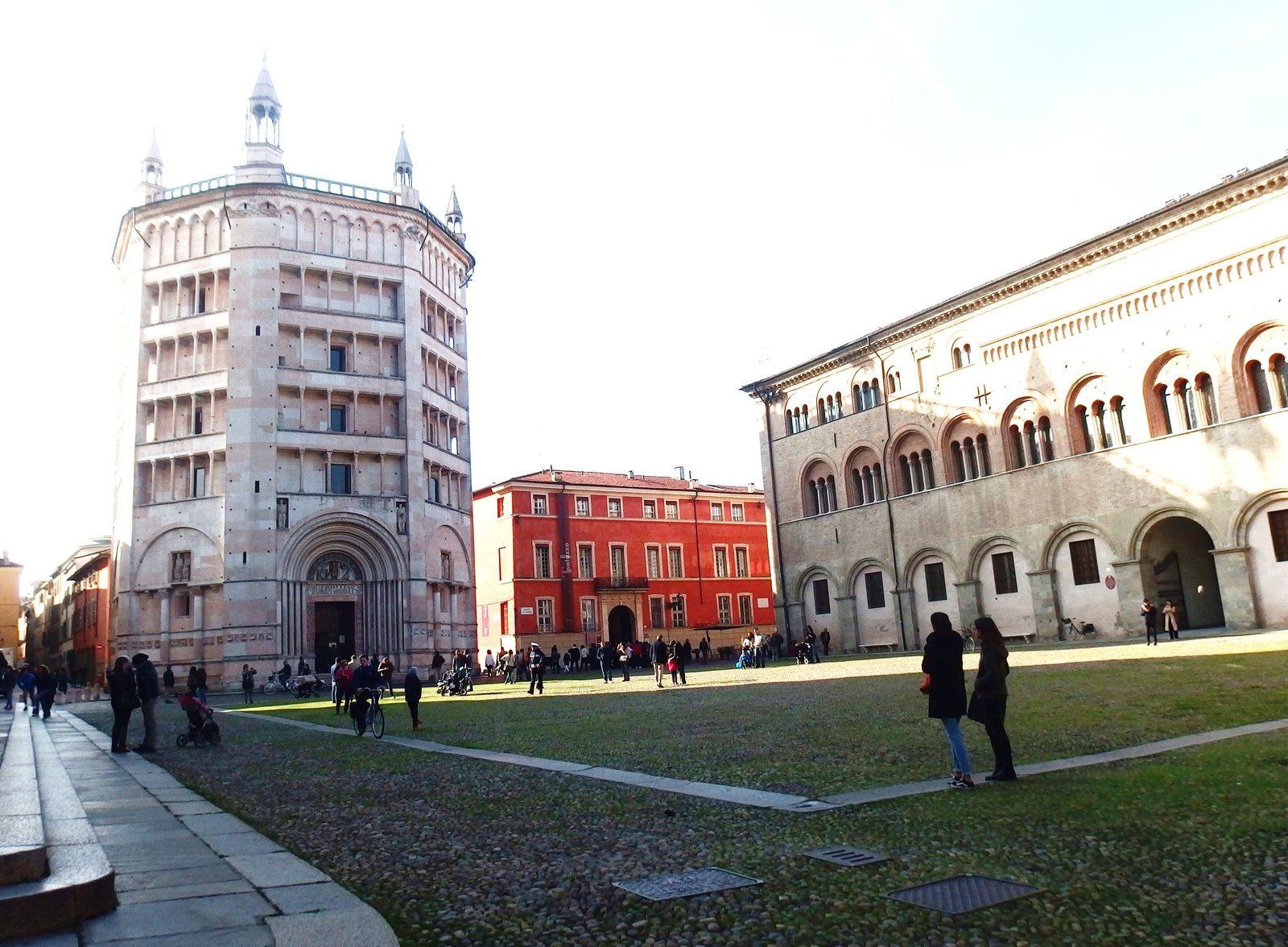 The Baptistery of Parma and the bishop's palace on a sunny square