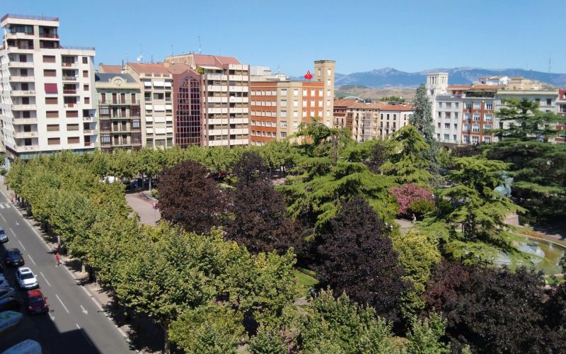View over the Espolón park and the rooftops of Logroño with mountains behind