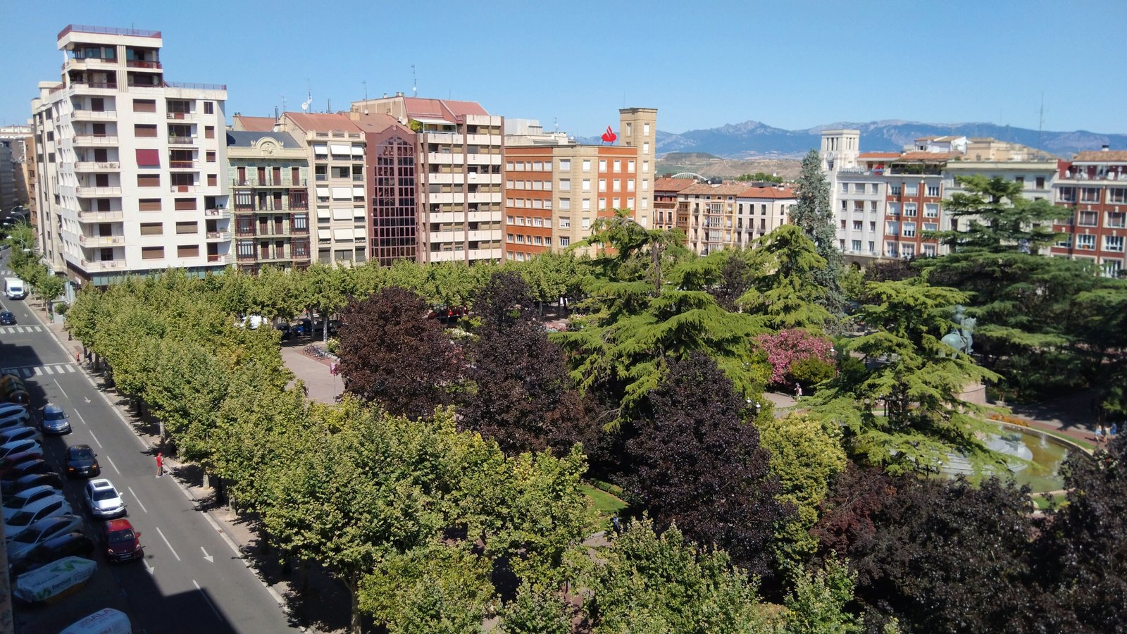 View over the Espolón park and the rooftops of Logroño with mountains behind