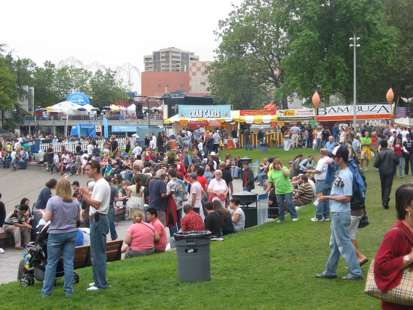 Visitors on a lawn among food stalls at the Bite of Seattle