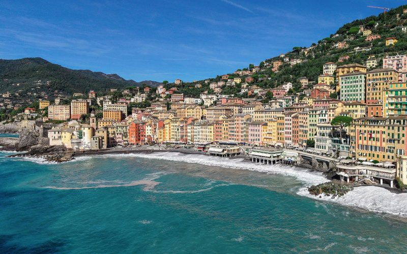 Colourful seafront houses of Camogli curving around a turquoise bay
