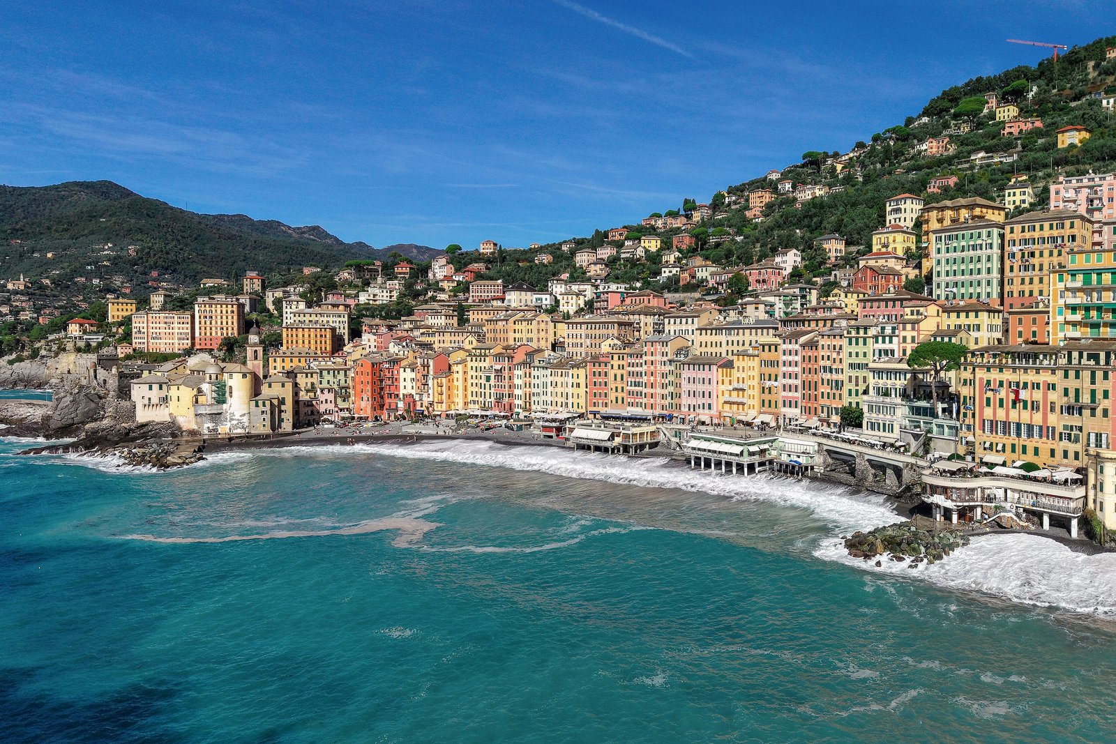 Colourful seafront houses of Camogli curving around a turquoise bay