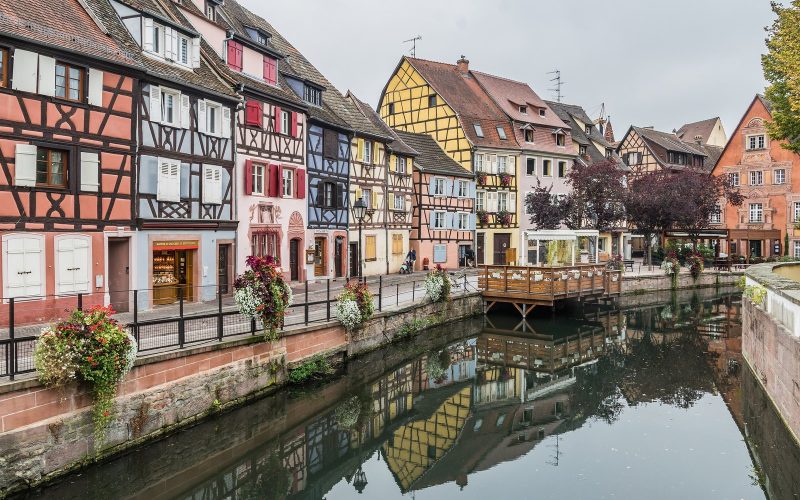 Half-timbered houses and flower boxes along a canal in Colmar, Alsace