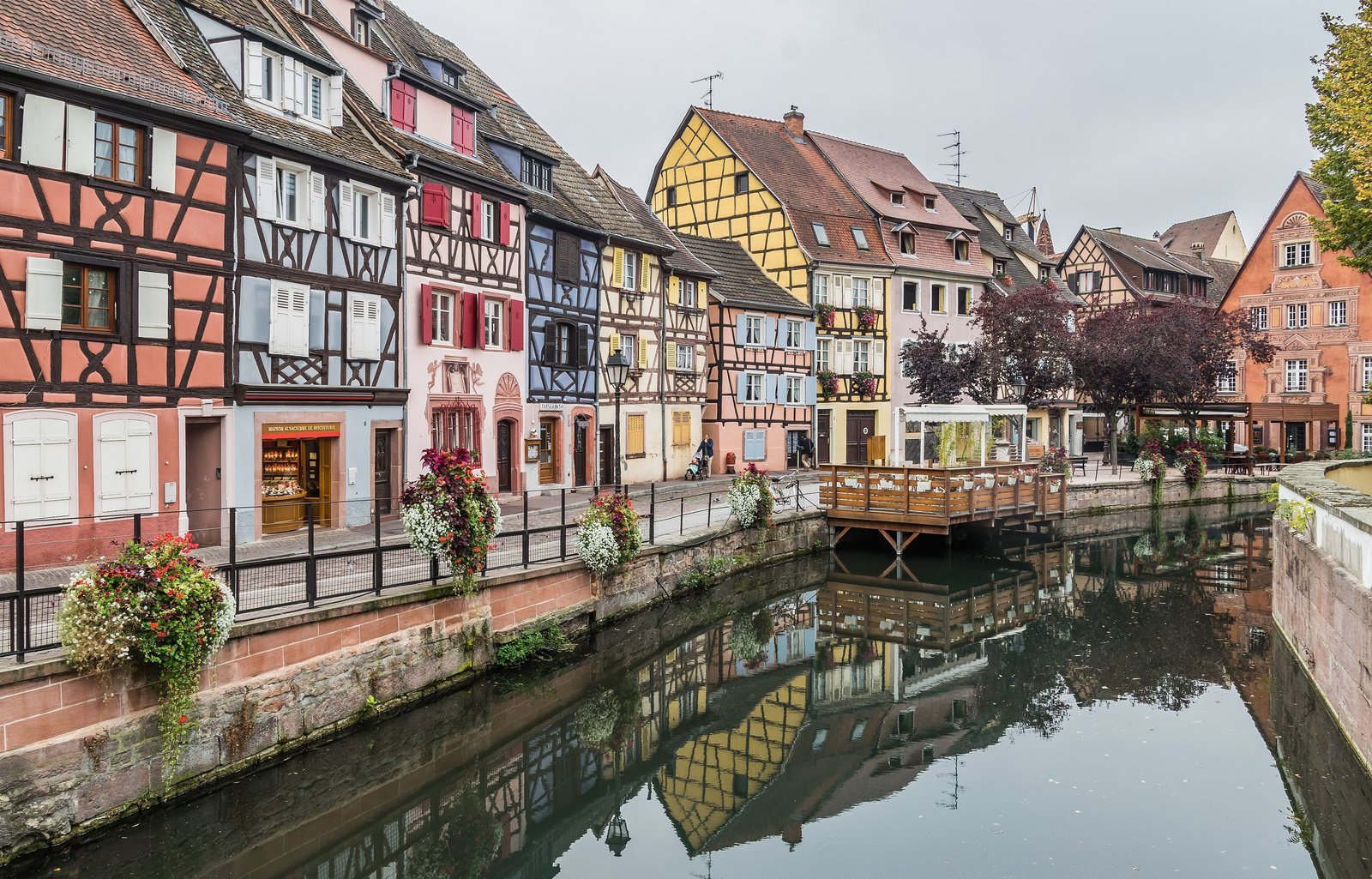 Half-timbered houses and flower boxes along a canal in Colmar, Alsace