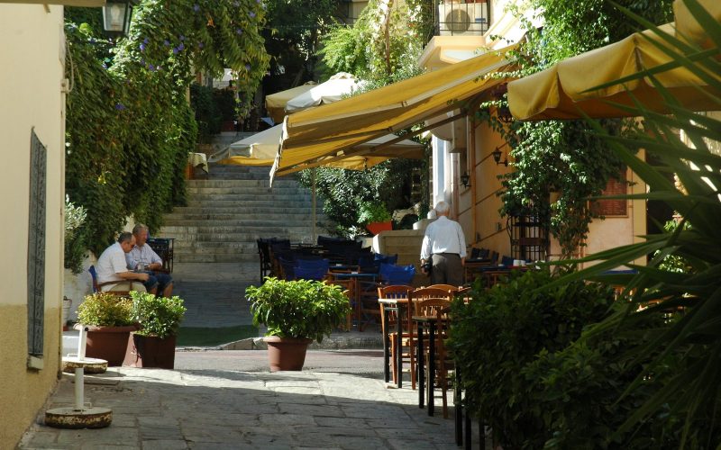 Shaded taverna terraces on a stepped lane in the Plaka district of Athens