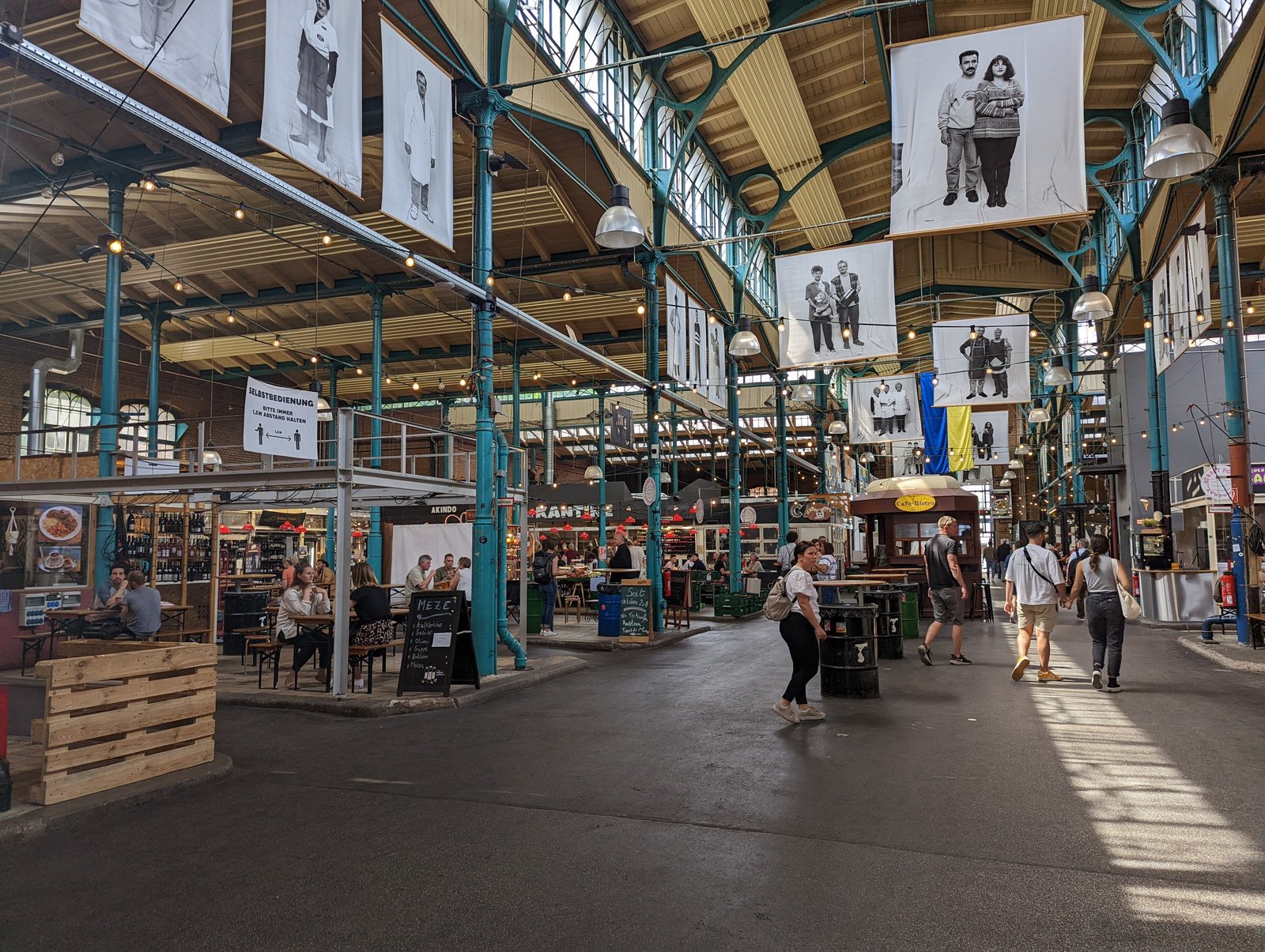 Light-filled iron market hall with food stalls at Markthalle Neun in Berlin Kreuzberg