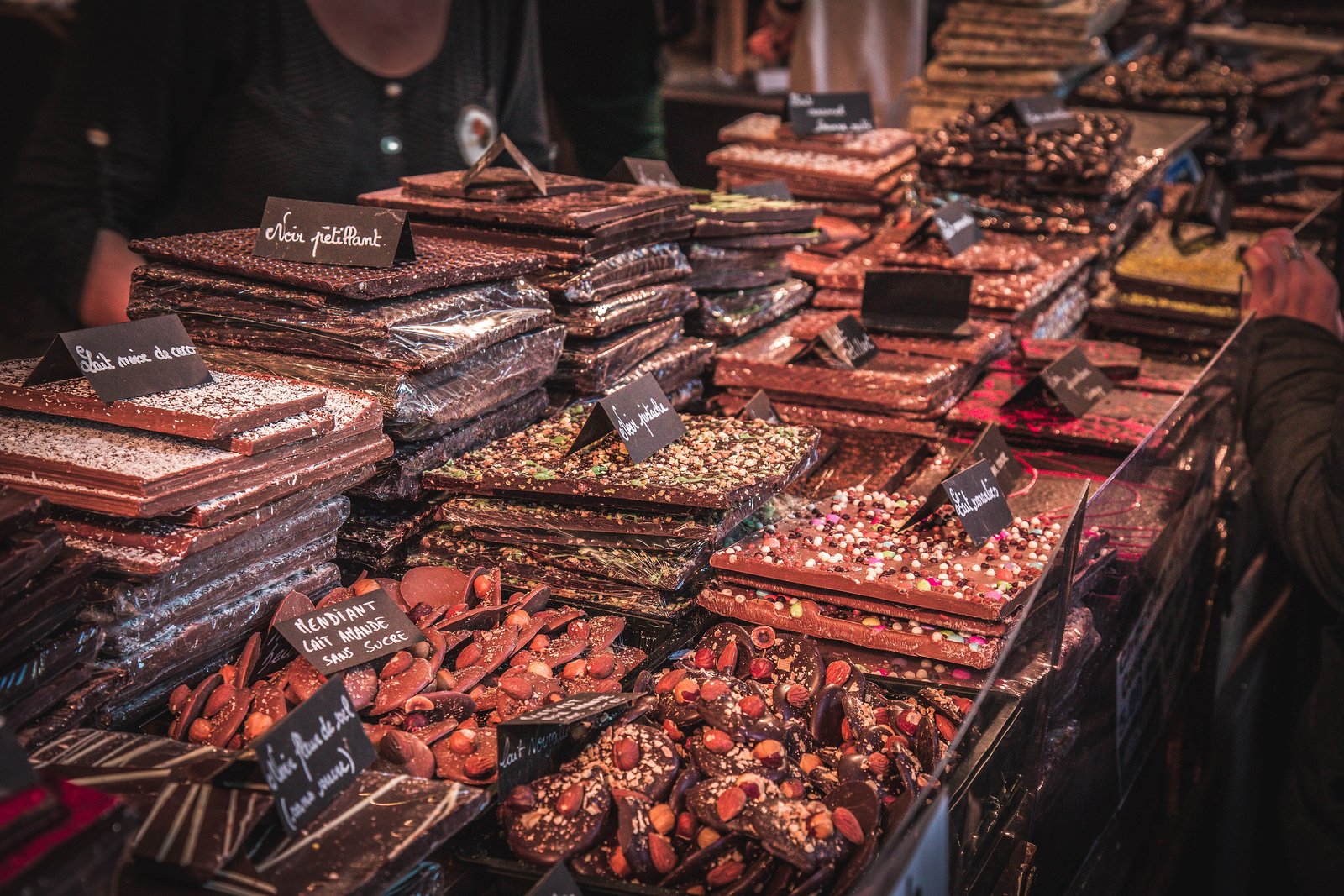 Stall piled with chocolate bars and slabs at the Salon du Chocolat in Paris