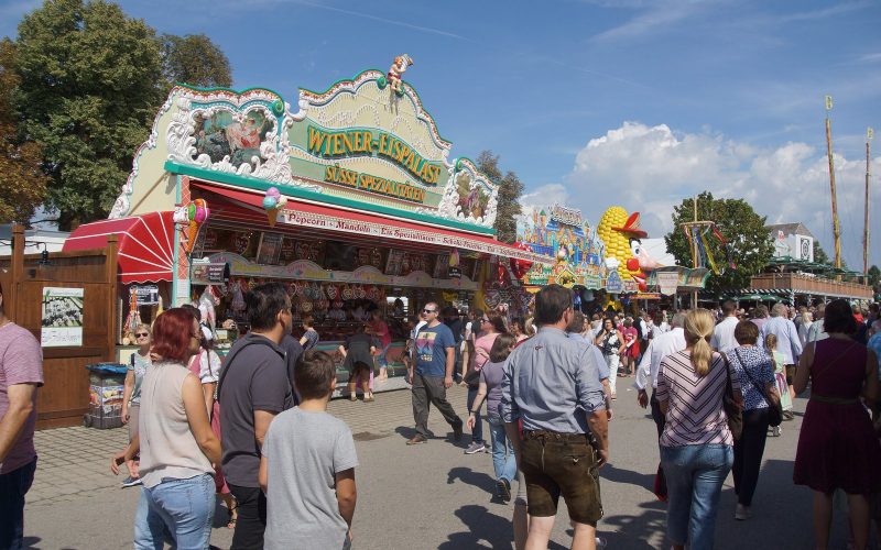 Visitors walking between fairground stalls at the Gäubodenvolksfest in Straubing