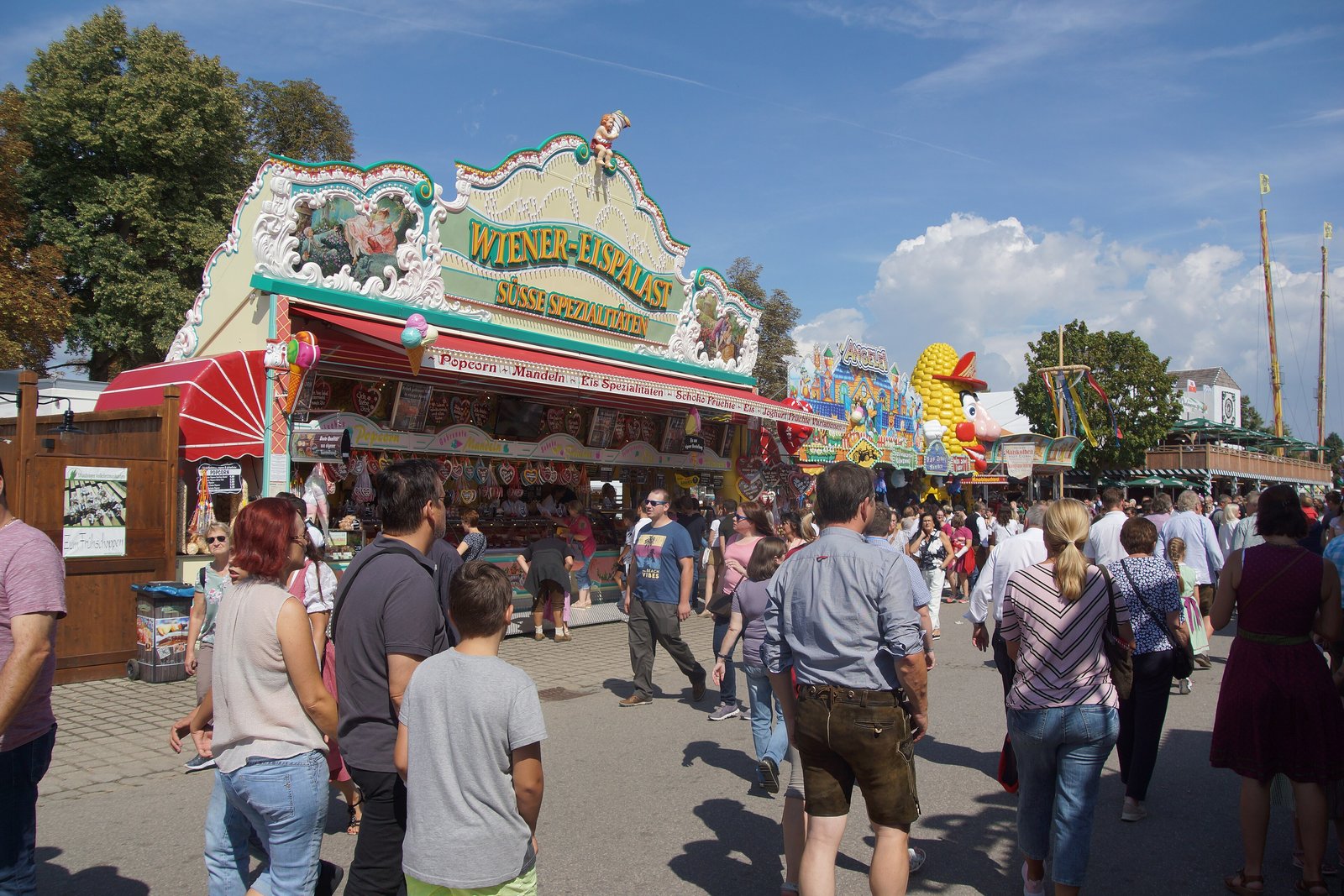 Visitors walking between fairground stalls at the Gäubodenvolksfest in Straubing