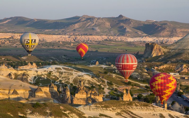 Hot air balloons over the rock valleys of Cappadocia at sunrise