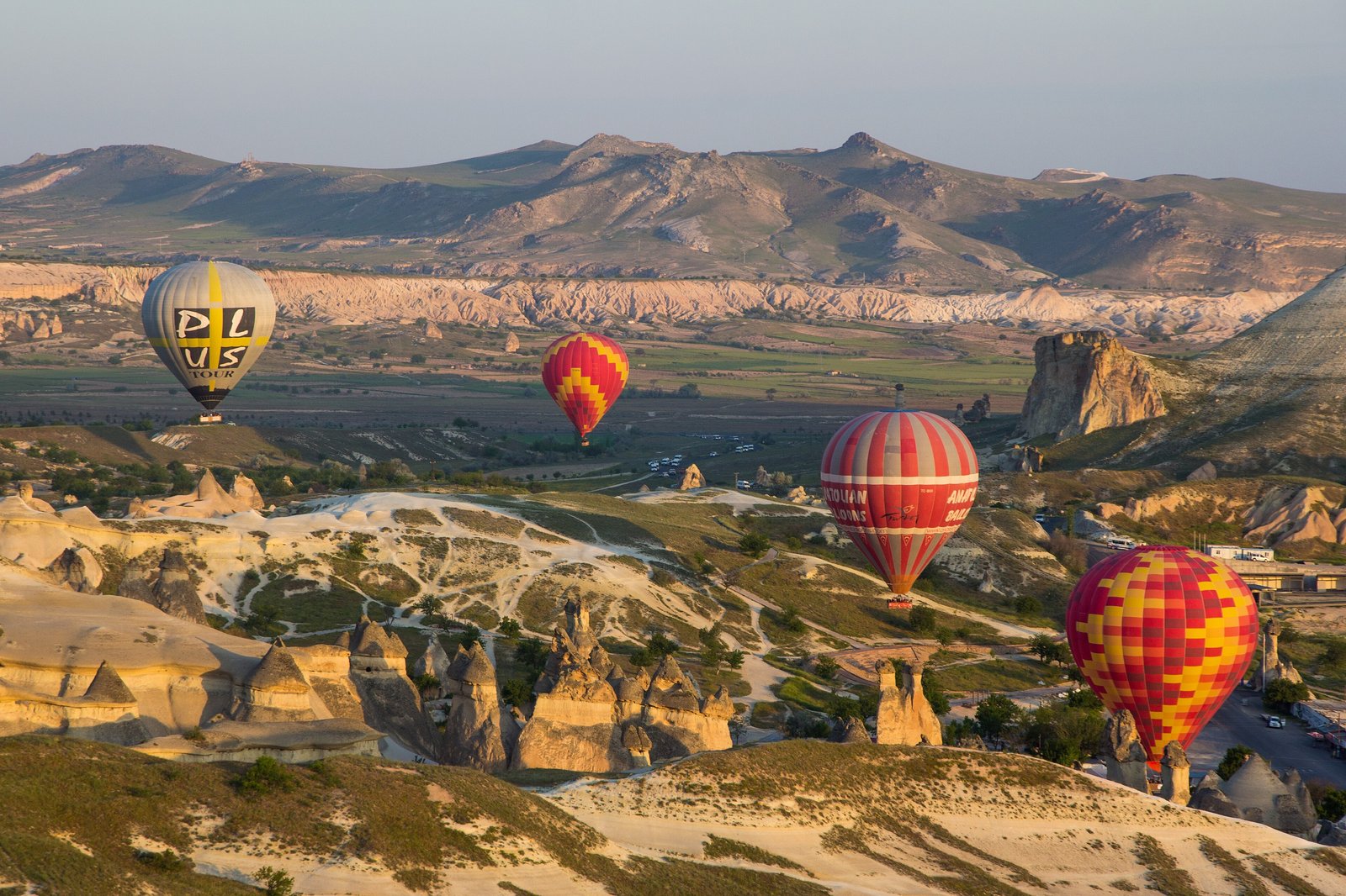 Hot air balloons over the rock valleys of Cappadocia at sunrise