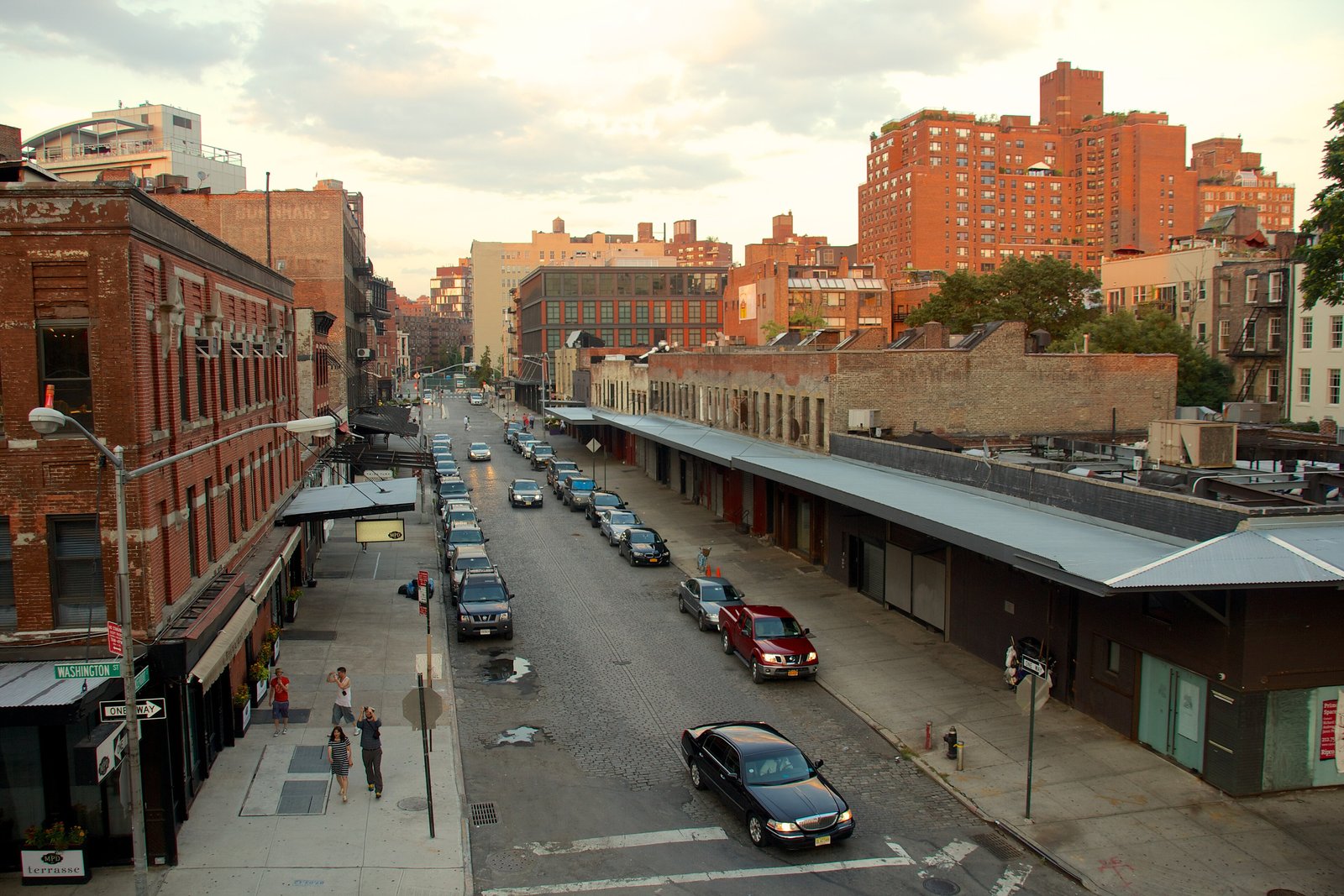 Brick warehouses and a street in Manhattan's Meatpacking District seen from the High Line at sunset