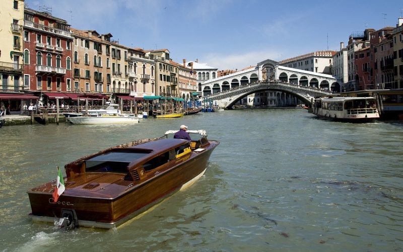 Rialto Bridge over the Grand Canal in Venice with a water taxi