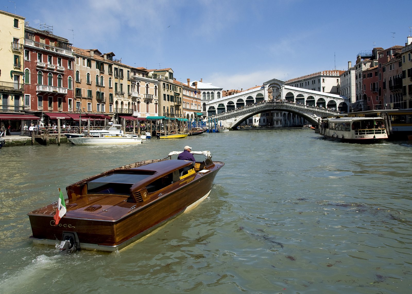 Rialto Bridge over the Grand Canal in Venice with a water taxi