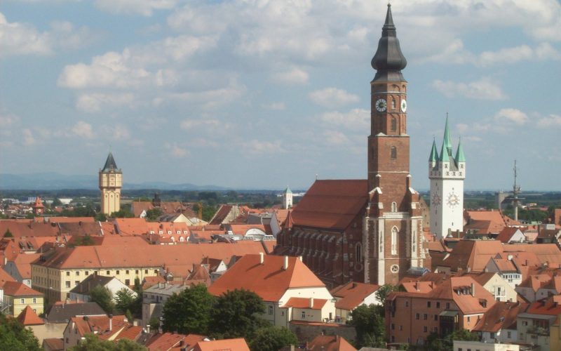 The tower of St James church rising over the red roofs of Straubing
