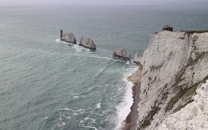 The Needles chalk stacks and lighthouse seen from the Isle of Wight cliffs