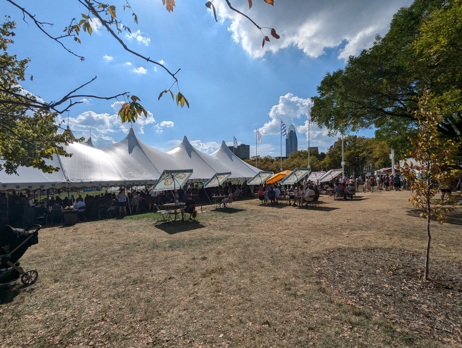 White festival tents on the Cincinnati riverfront with the downtown skyline behind