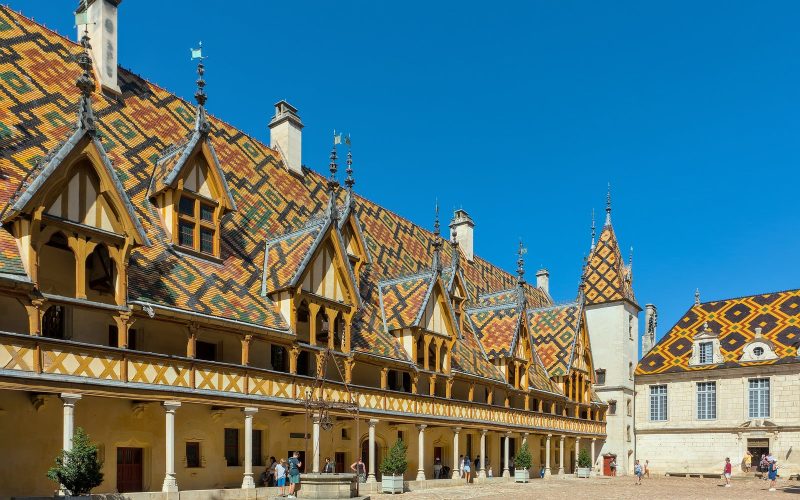 Courtyard of the Hôtel-Dieu in Beaune with its glazed multicoloured tile roofs