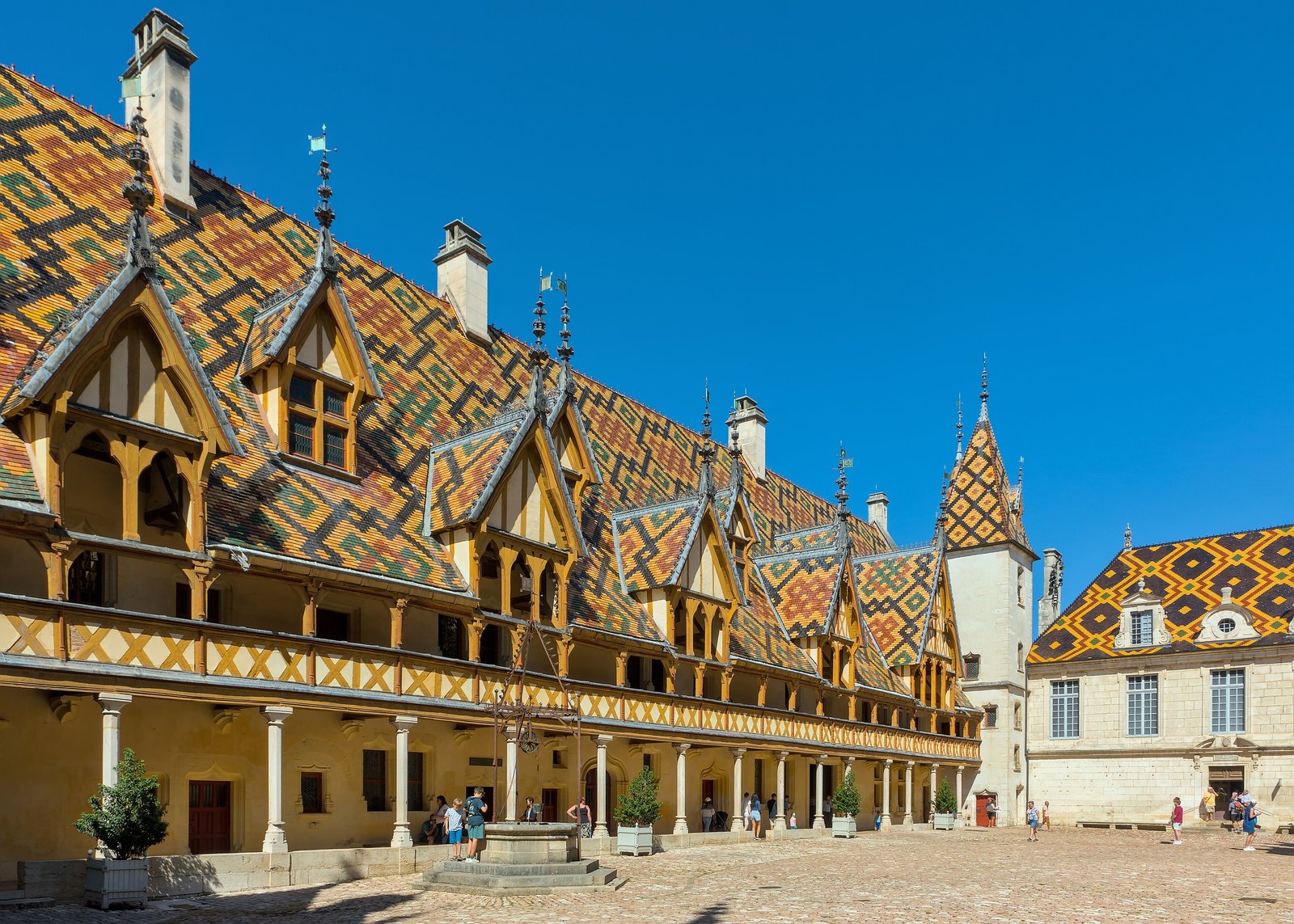 Courtyard of the Hôtel-Dieu in Beaune with its glazed multicoloured tile roofs