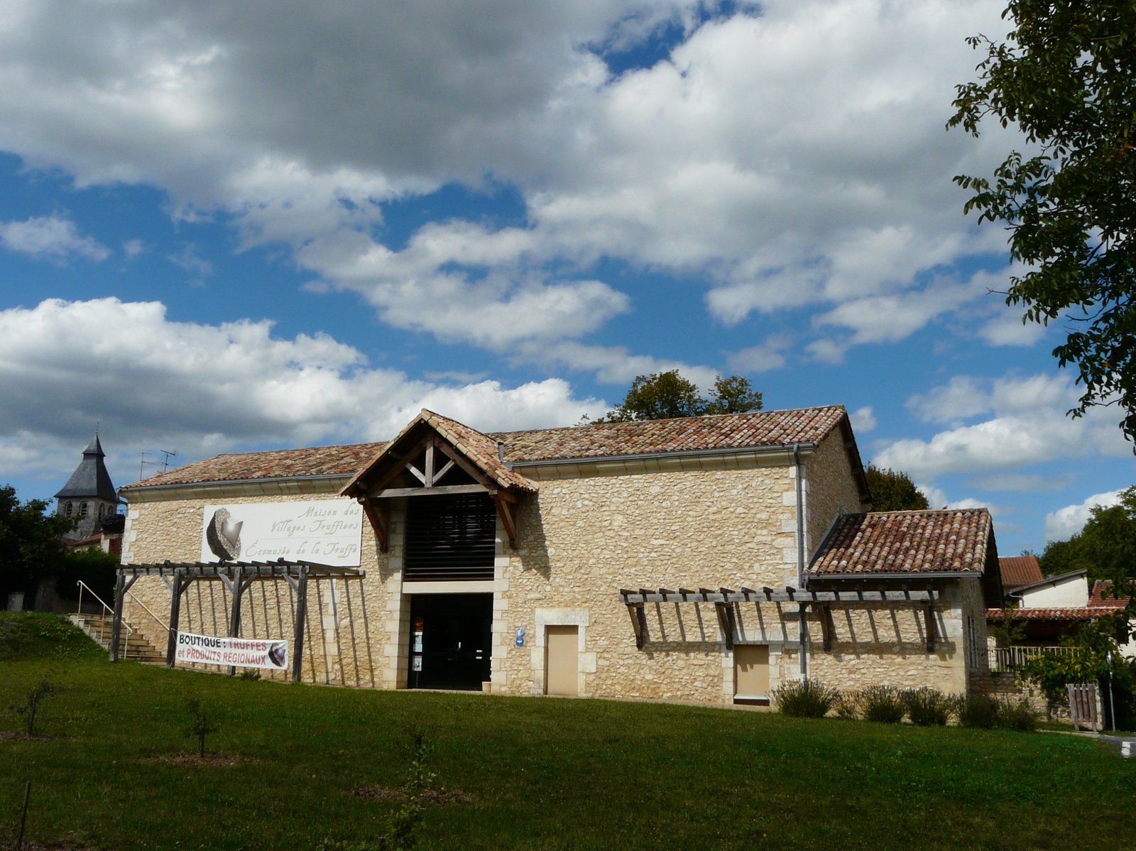 Truffle ecomuseum, a stone building under a blue sky in Sorges, Périgord