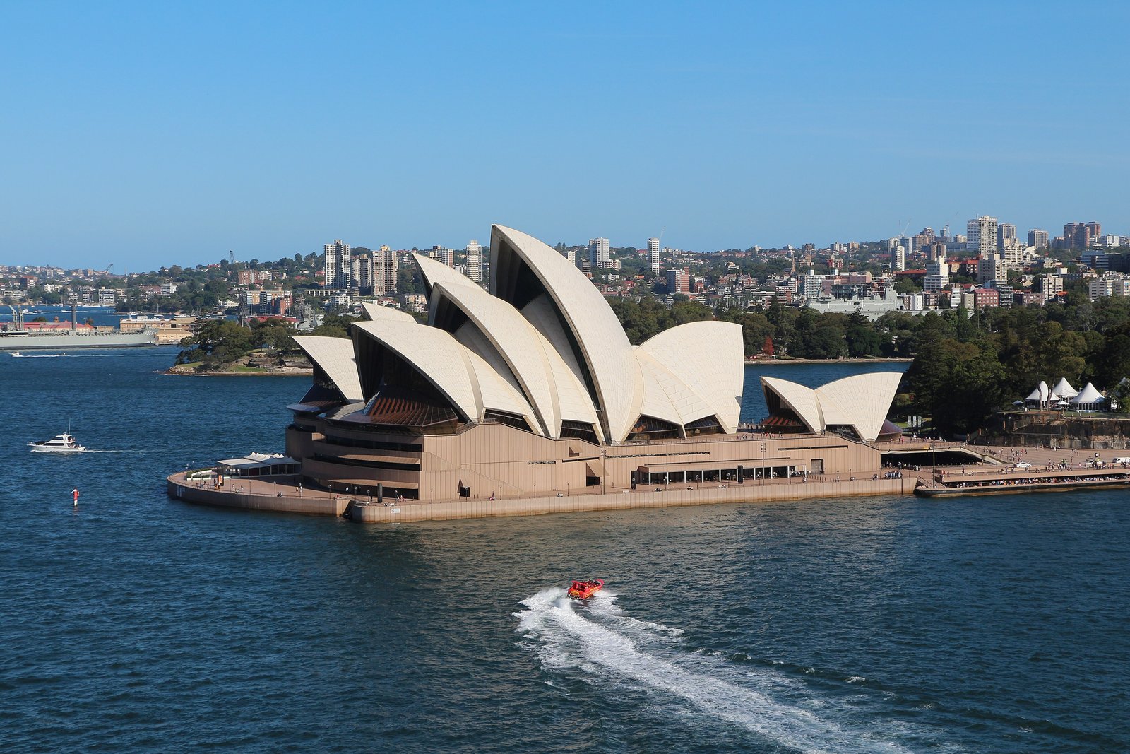 Sydney Opera House on the harbour under a blue sky