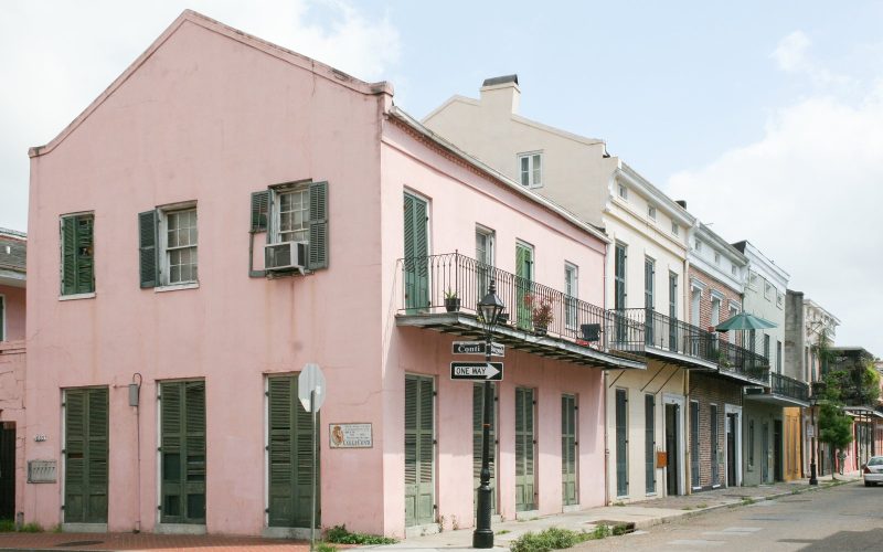 Pink Creole townhouse with green shutters in the French Quarter