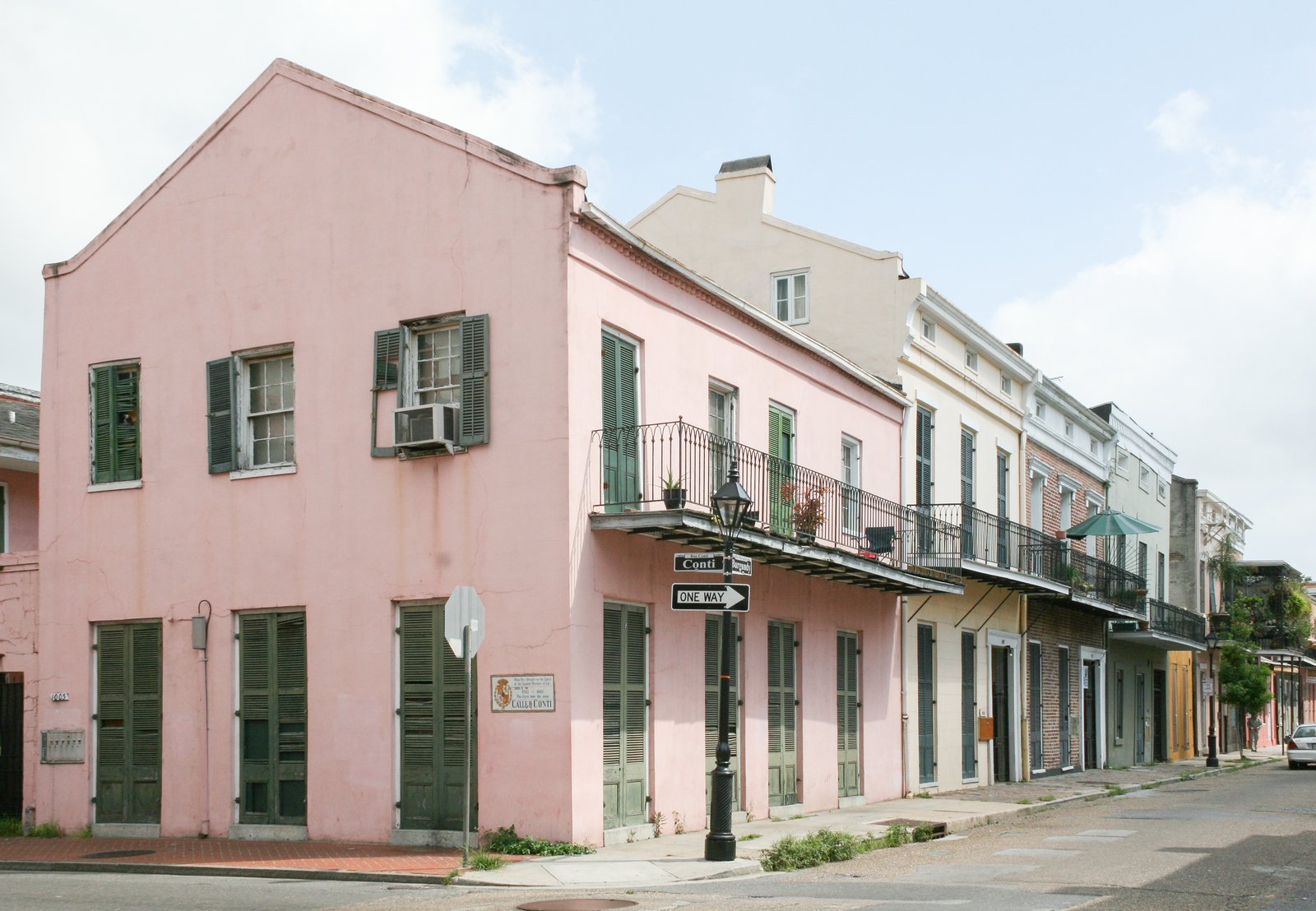 Pink Creole townhouse with green shutters in the French Quarter