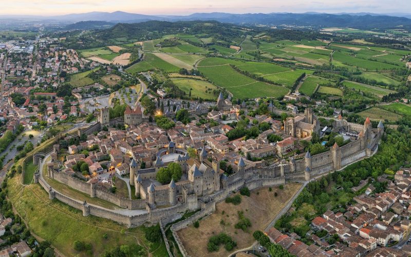 Aerial view of the walled Cité of Carcassonne and the surrounding fields in Occitanie