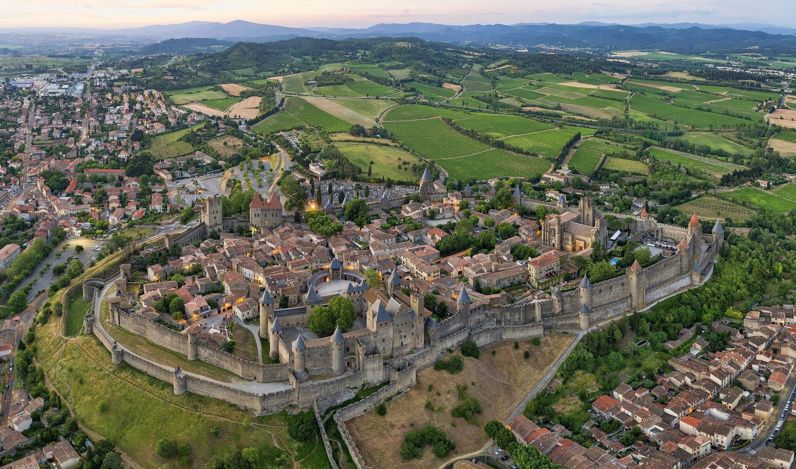 Aerial view of the walled Cité of Carcassonne and the surrounding fields in Occitanie