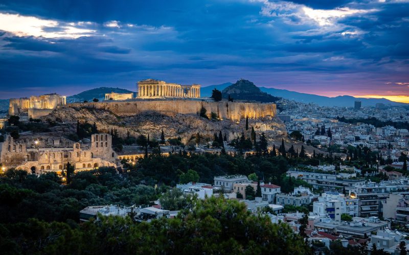 The Acropolis of Athens lit at blue hour above the city rooftops