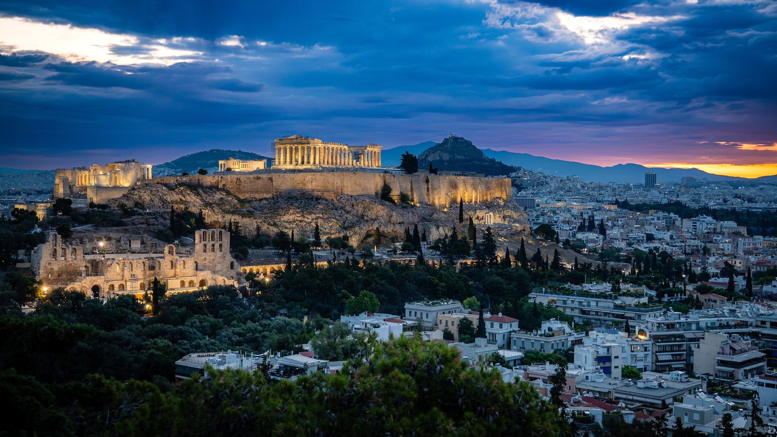 The Acropolis of Athens lit at blue hour above the city rooftops