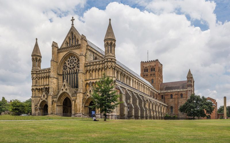 St Albans Cathedral seen across the lawn under a cloudy summer sky