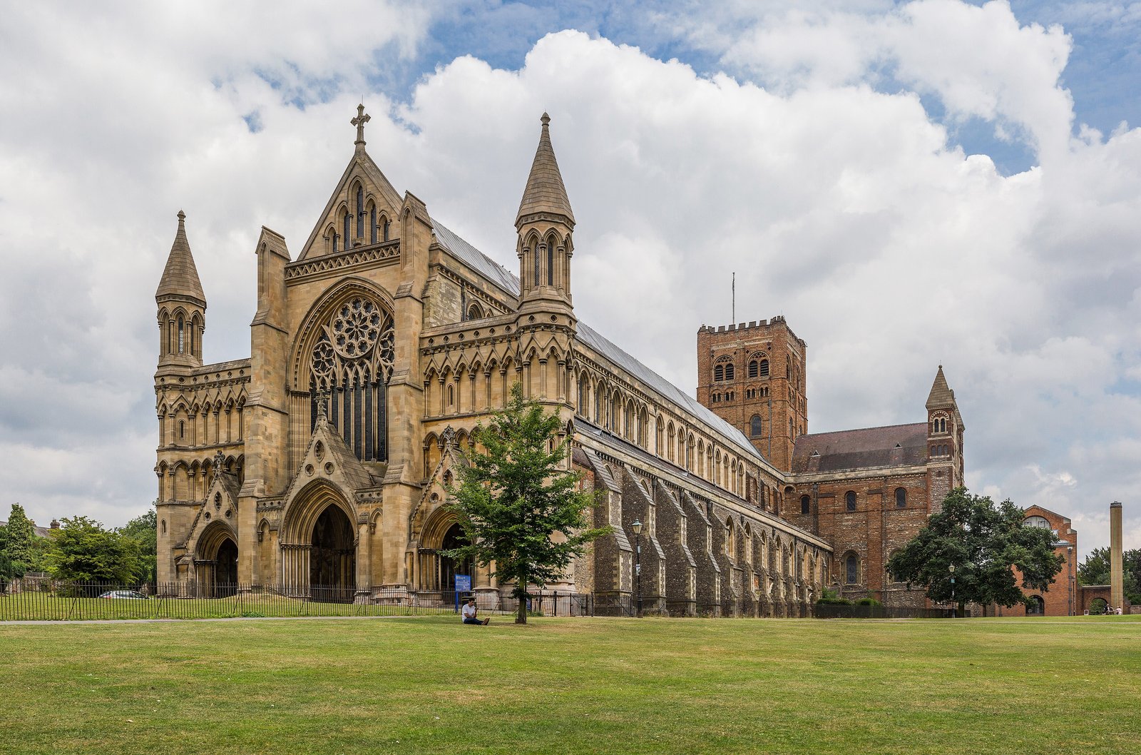St Albans Cathedral seen across the lawn under a cloudy summer sky