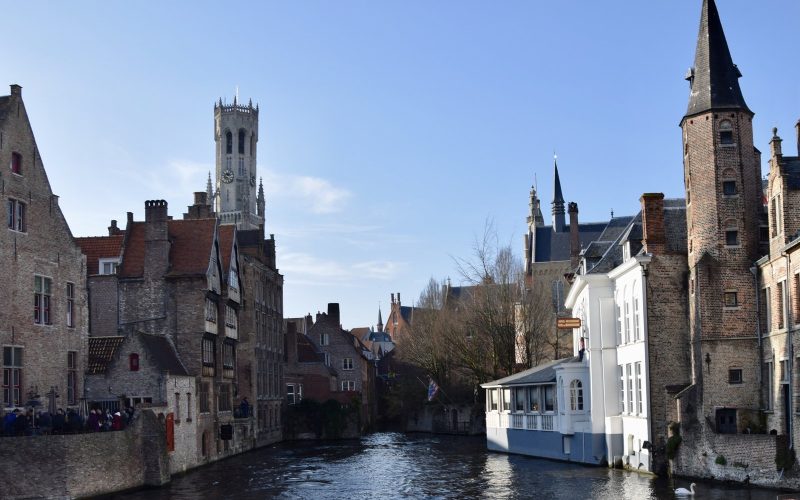 Canal, medieval houses and the Belfry tower in Bruges