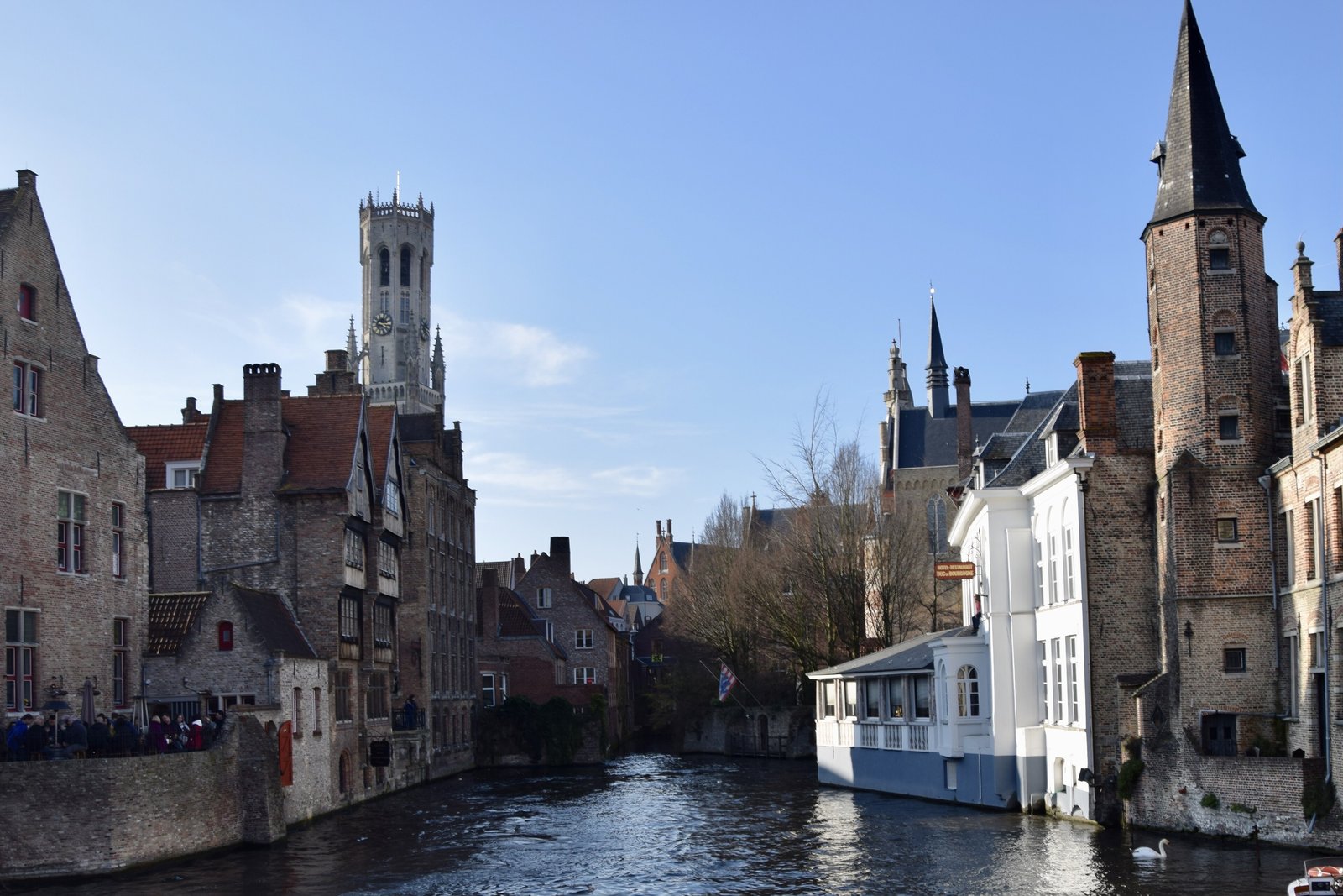 Canal, medieval houses and the Belfry tower in Bruges