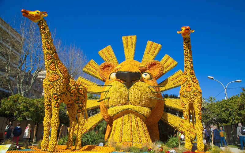 Giant lion and giraffe sculptures made of lemons and oranges at the Fête du Citron in Menton